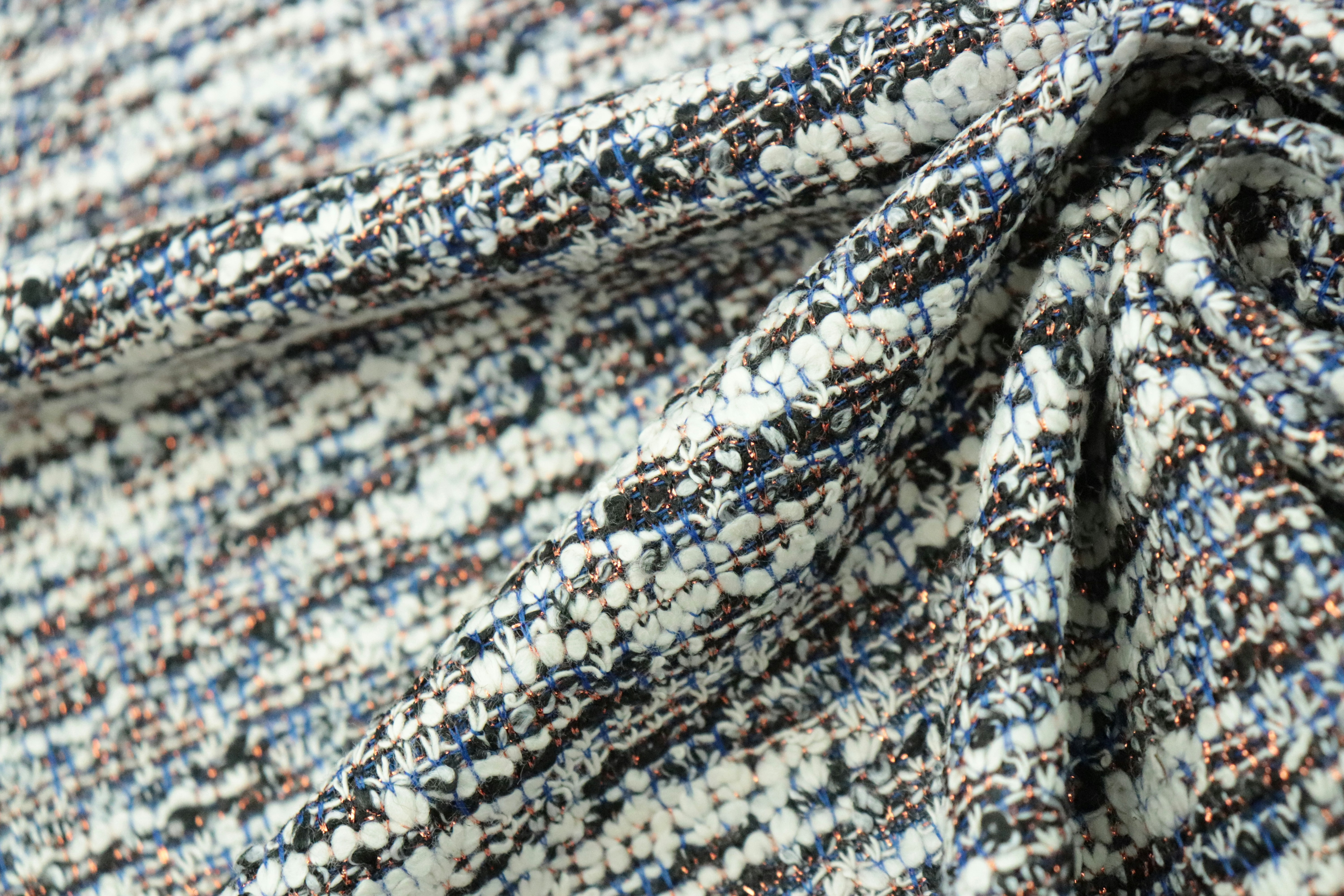 a close up of a blue and white tweed fabric