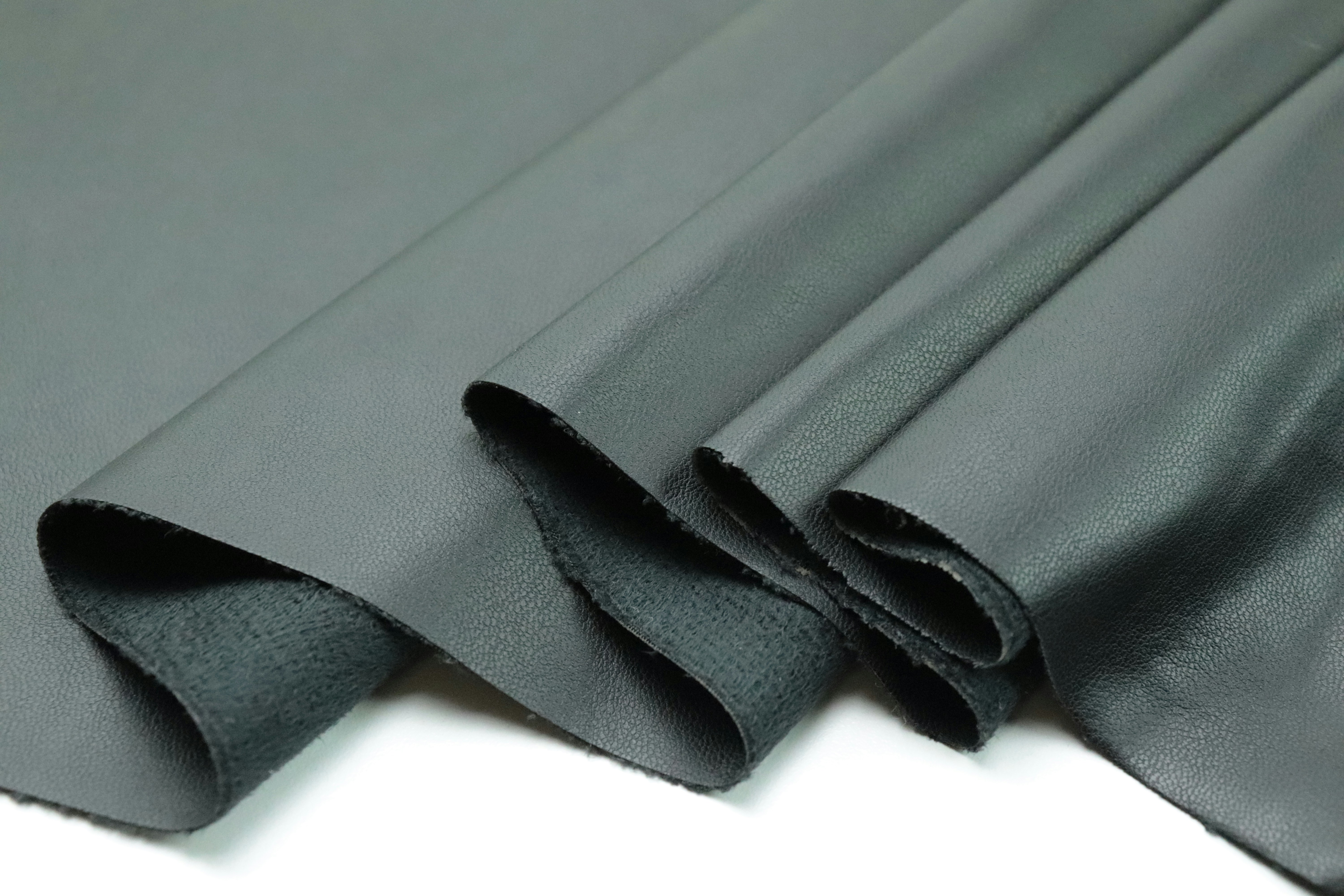 a close up of a black cloth on a white surface