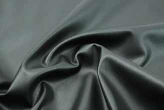 a close up shot of a dark green fabric