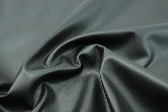 a close up shot of a dark green fabric