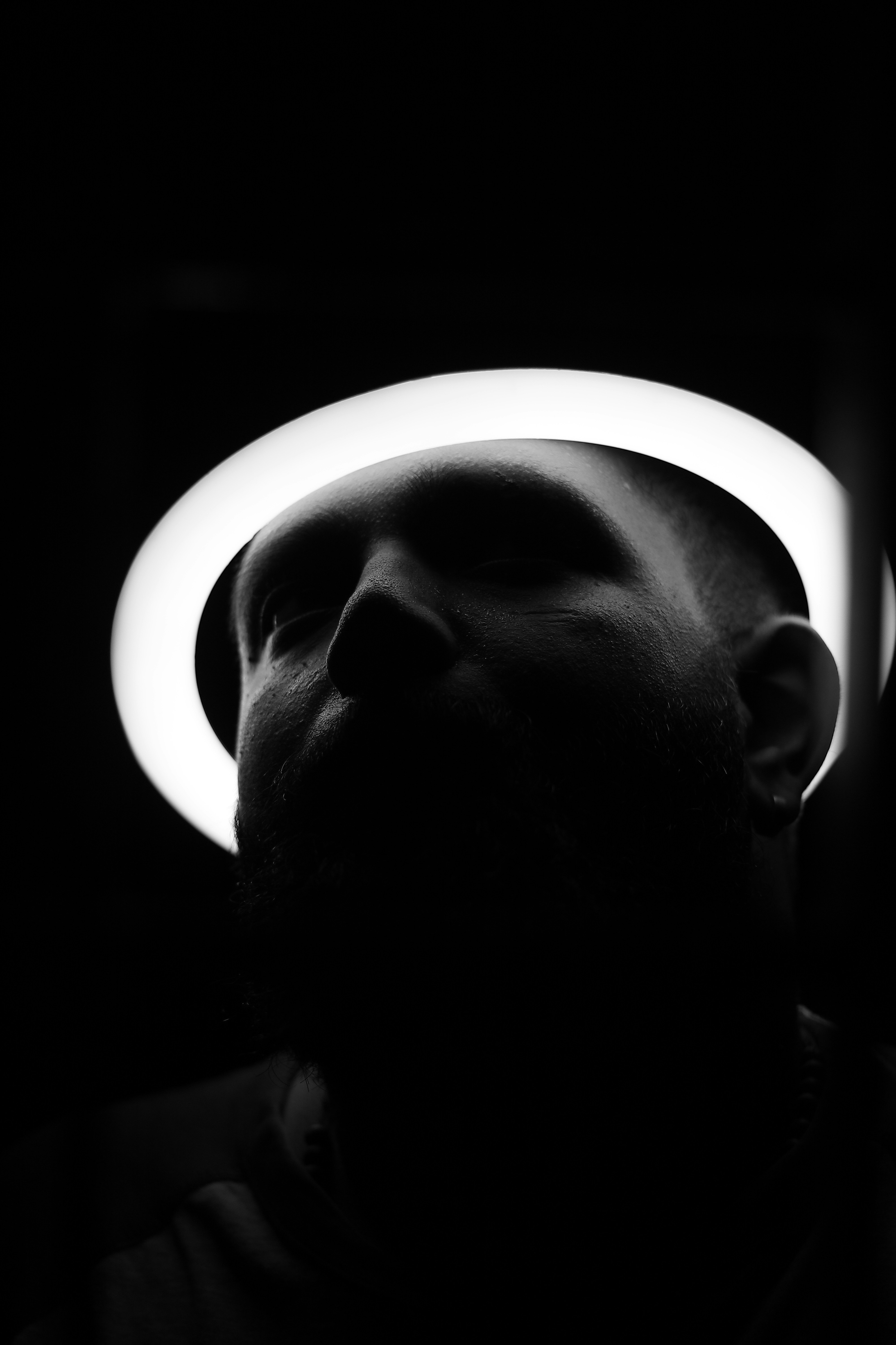 a black and white photo of a man with a hat