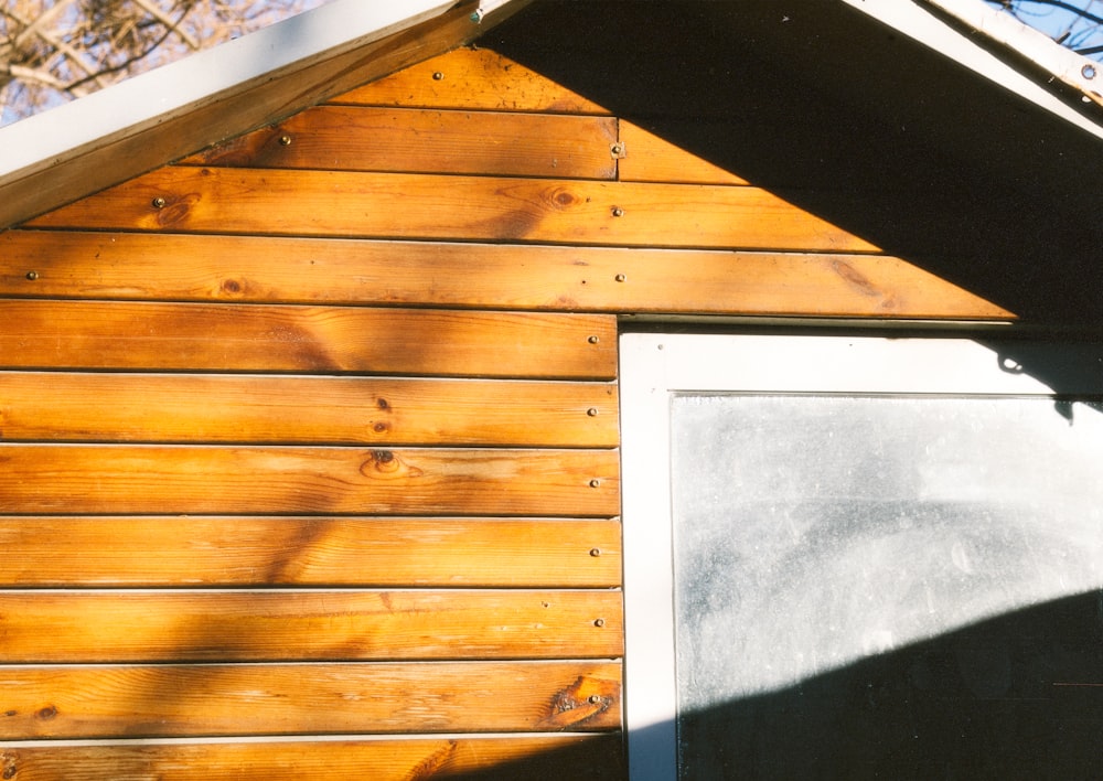 a close up of a wooden building with a window