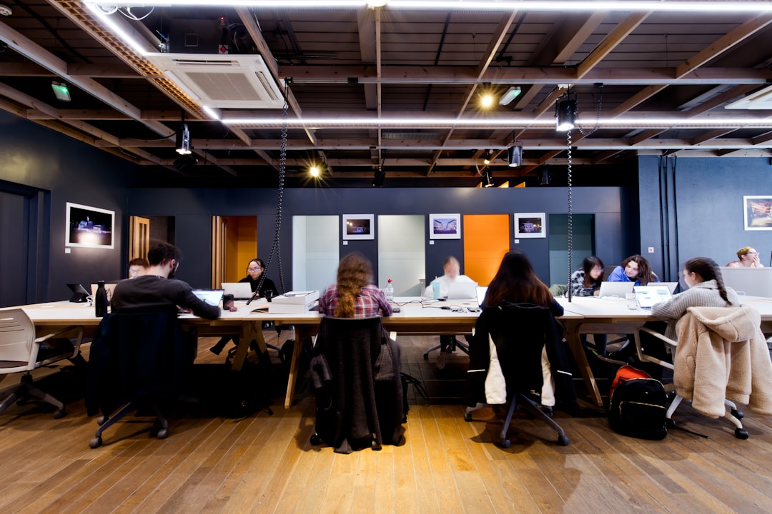 a group of people sitting around a table,