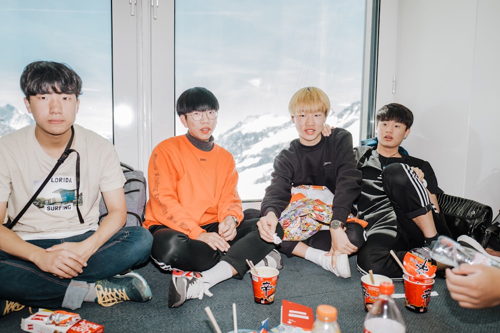 a group of young men sitting next to each other