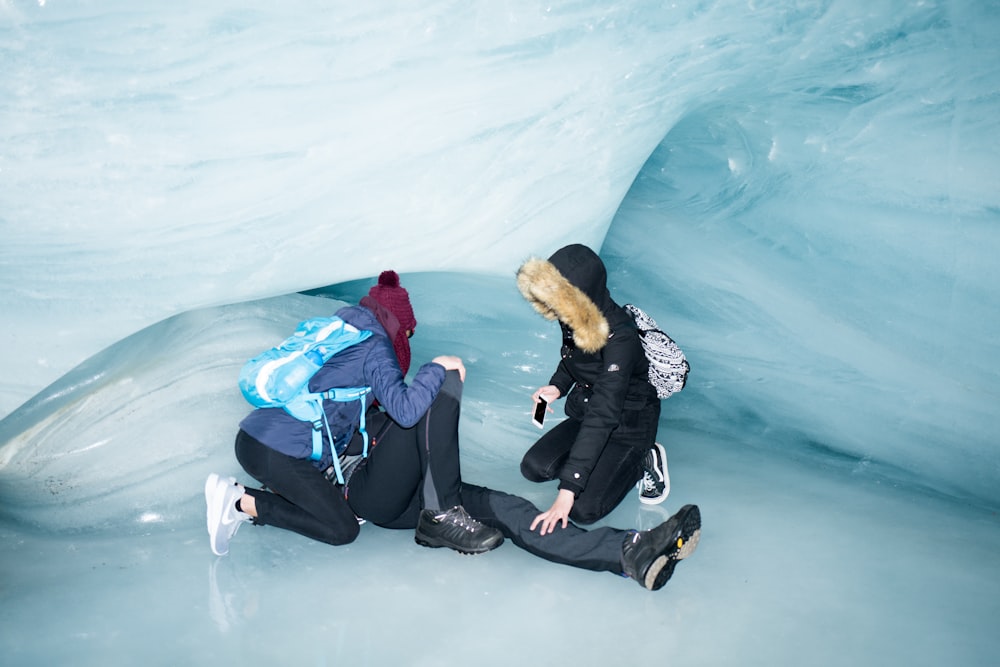 a couple of people that are sitting on some ice