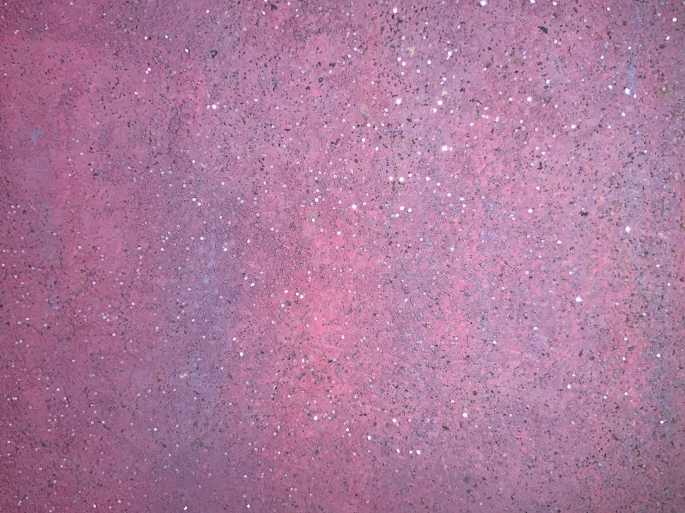 a close up of a pink and purple surface