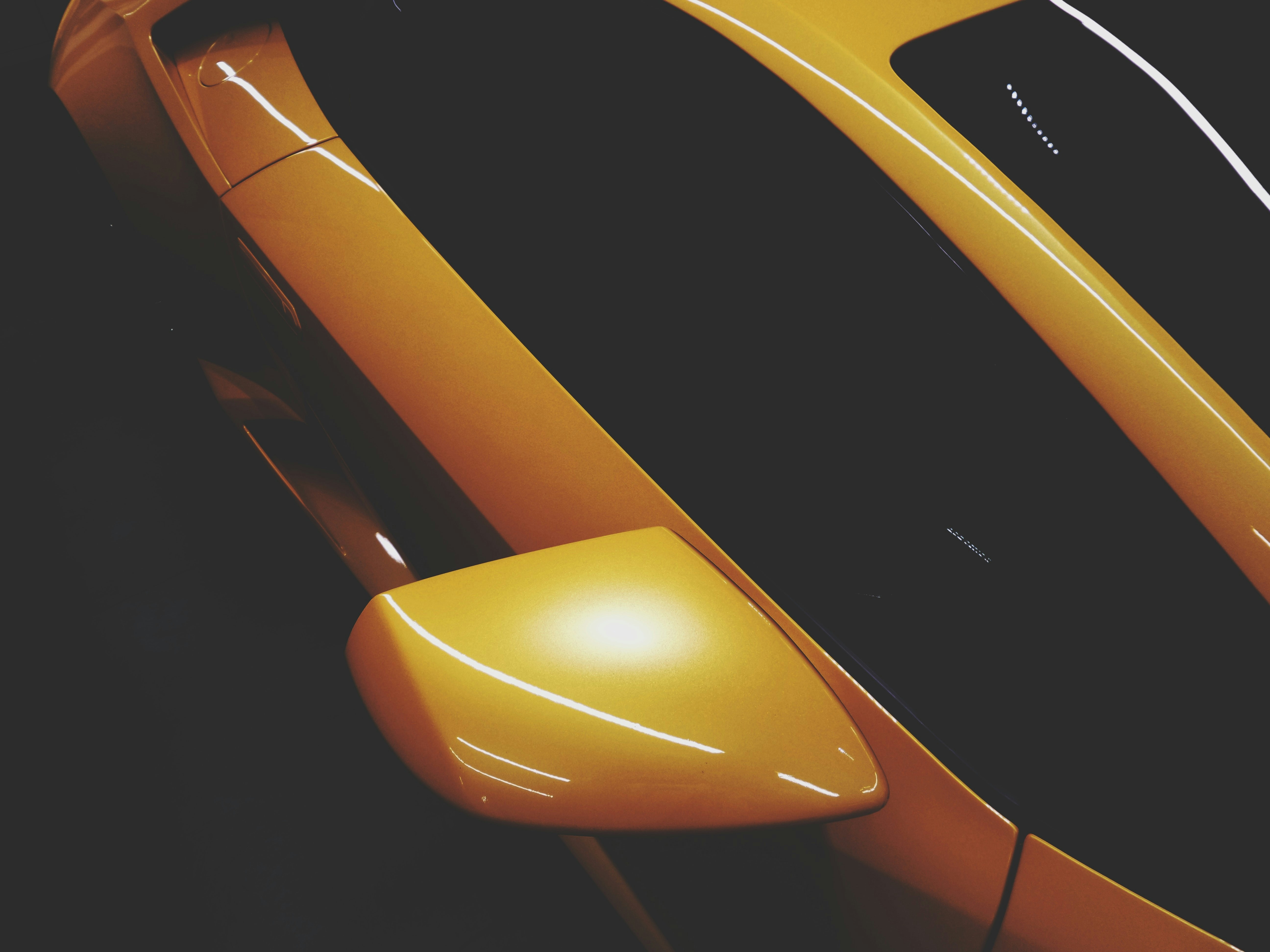 a close up of a yellow sports car