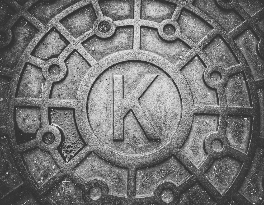 a black and white photo of a manhole cover