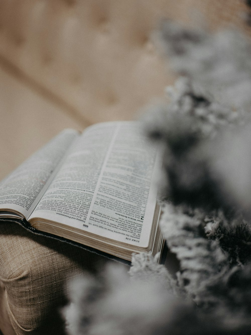 an open book sitting on top of a couch