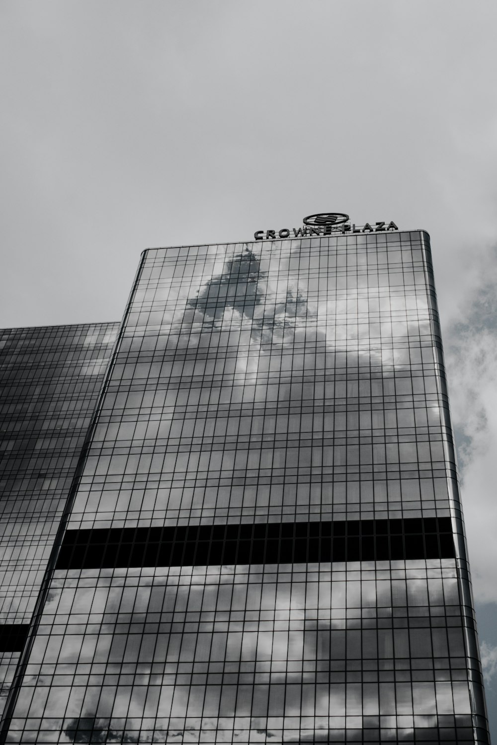 a tall building with a sky reflection in it