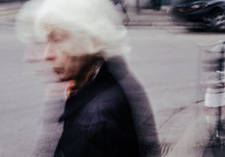 a blurry photo of a man walking down a street