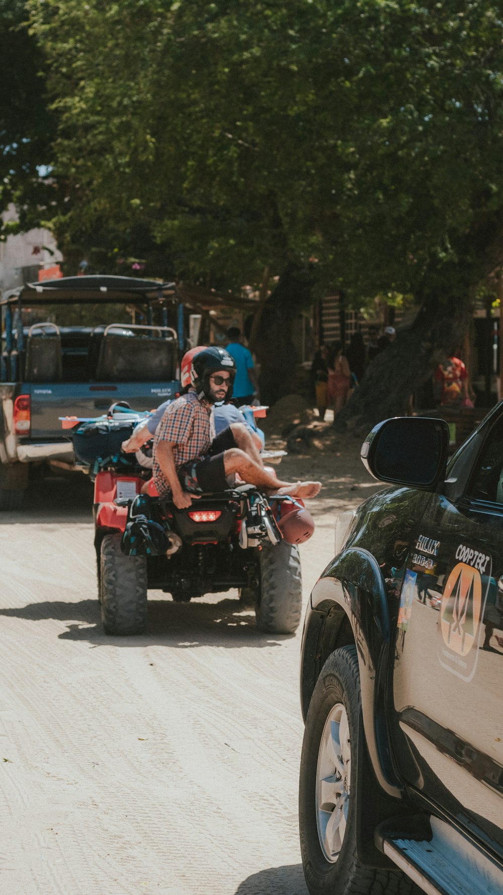 a man riding on the back of a four wheeler