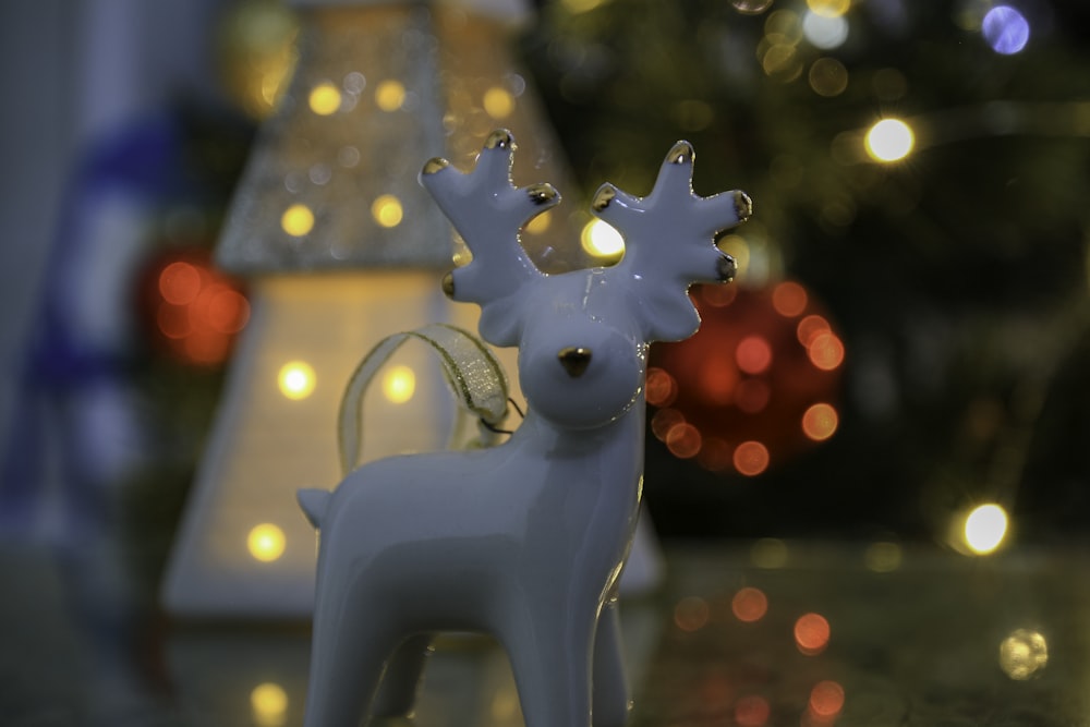 a white christmas ornament with a reindeer head