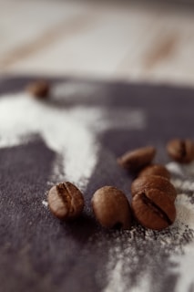 Artistic shot of freshly ground coffee powder dusted on a wooden surface.