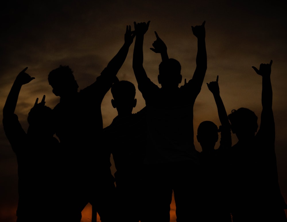 a group of people raising their hands in the air