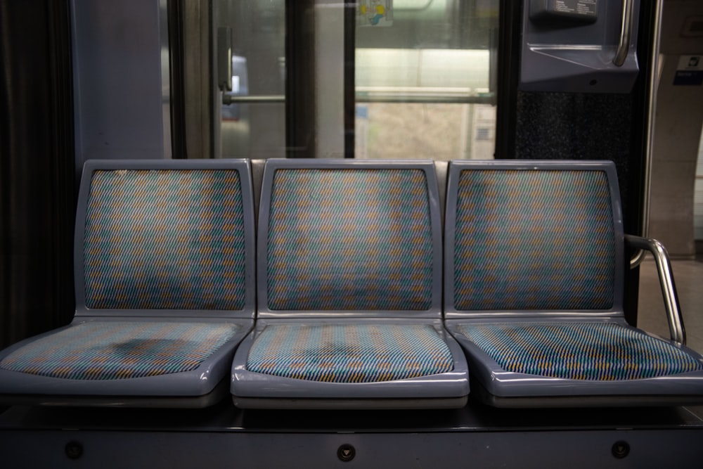 a row of seats sitting next to each other on a train