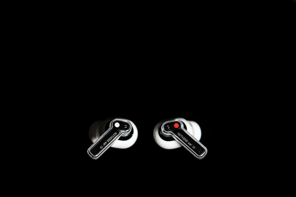 a pair of black and white ear buds in the dark