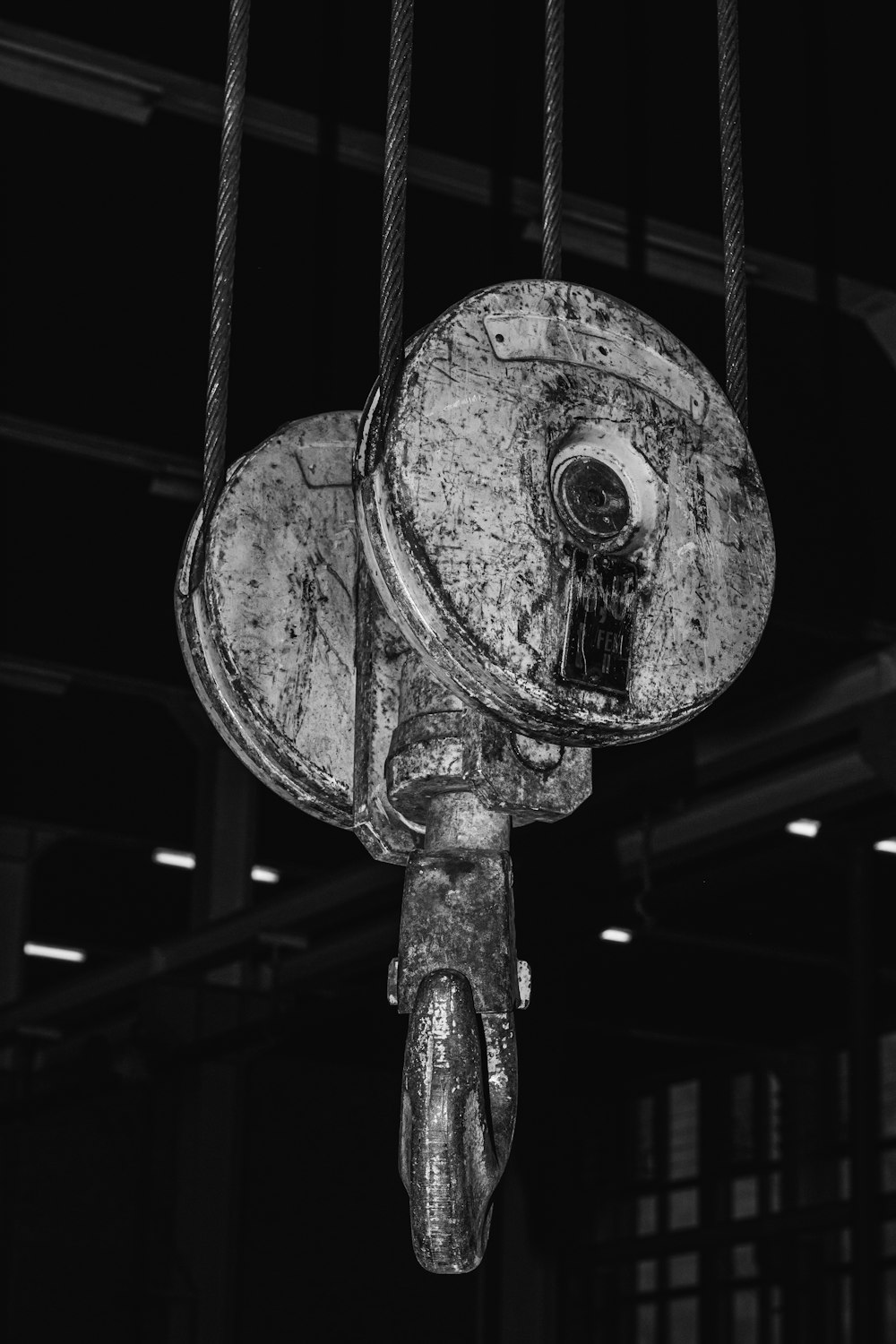 an old fire hydrant hanging from a rope in a building