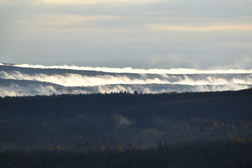 a view of a mountain range covered in fog