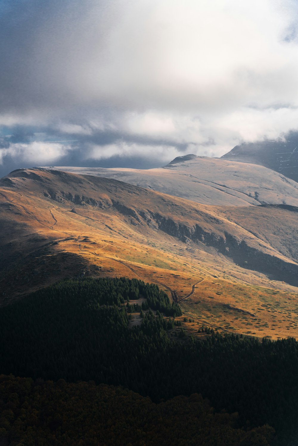 a view of a mountain range with clouds in the sky