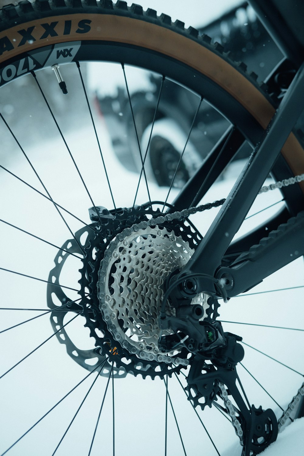 a close up of a bike tire on a snowy day