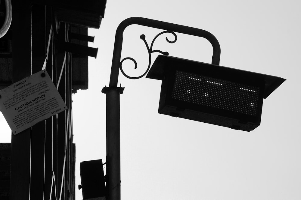 a black and white photo of a street light