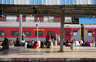 a group of people standing on a platform next to a train