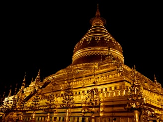 a large building lit up at night with lights on it