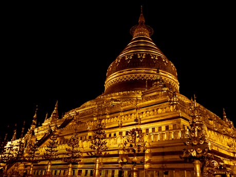 a large building lit up at night with lights on it