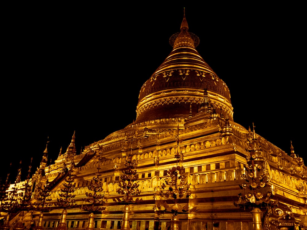 a large building lit up at night with lights on it