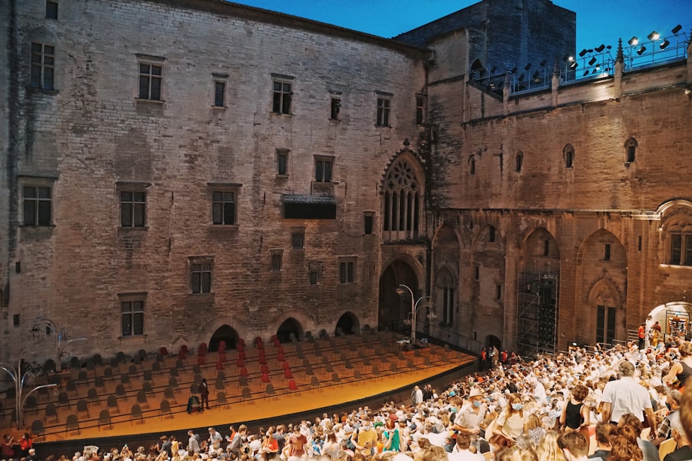 a large crowd of people standing around a stage