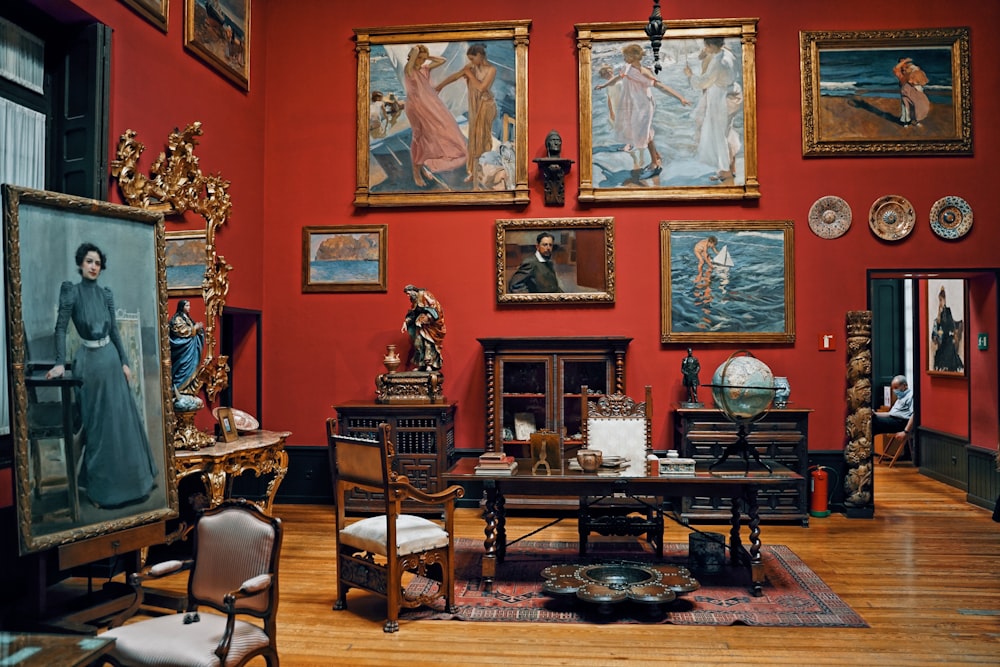 a living room filled with lots of paintings and furniture