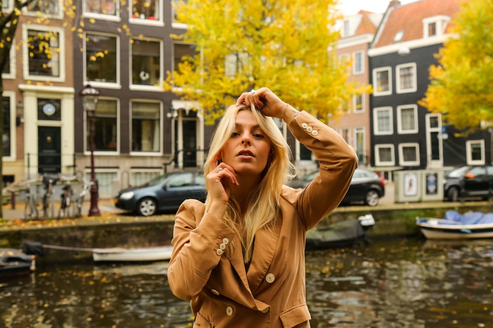 a woman standing next to a body of water