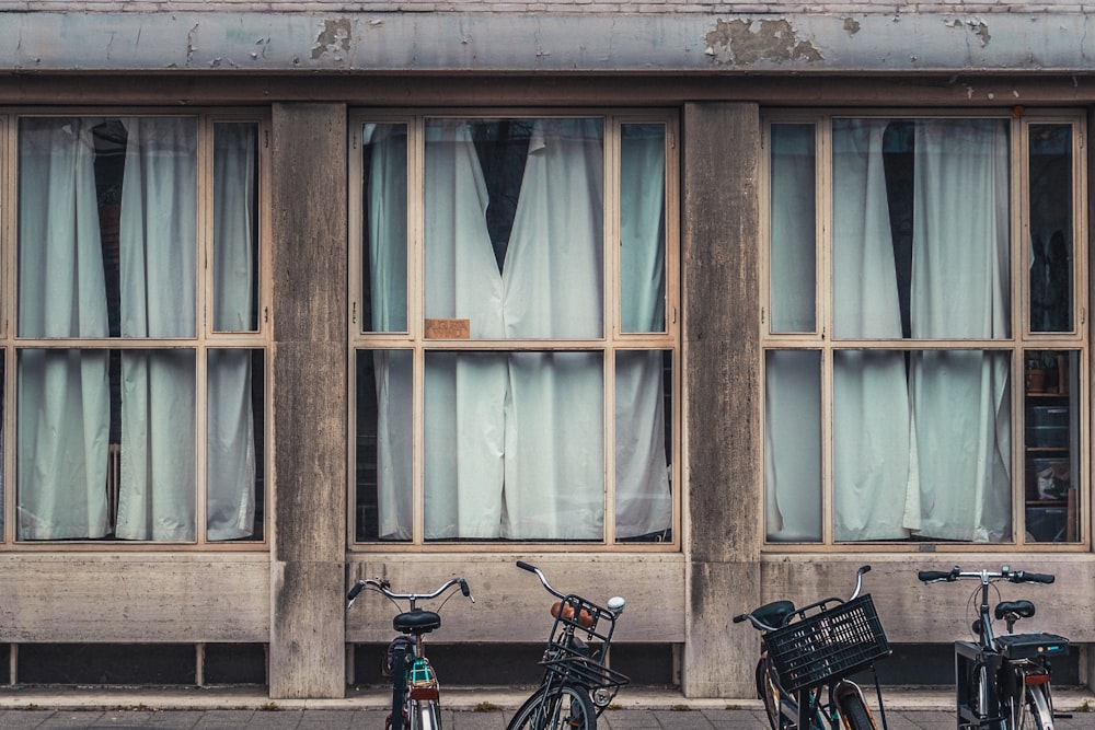 two bicycles parked in front of a building