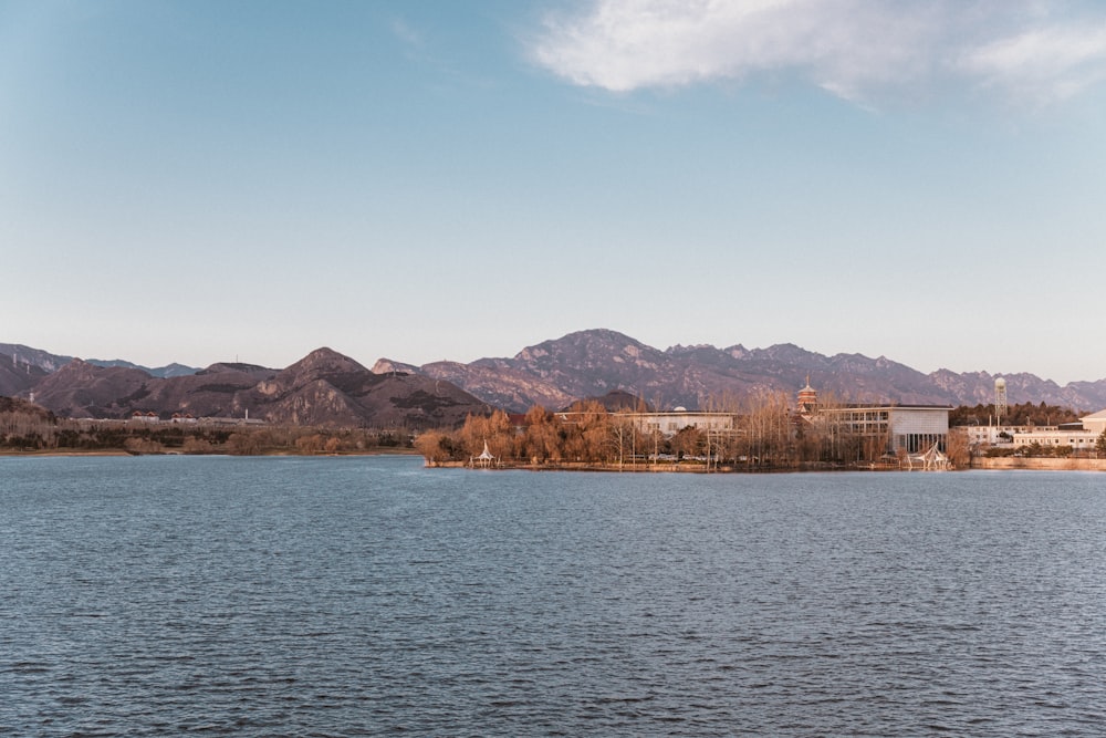 a large body of water with mountains in the background