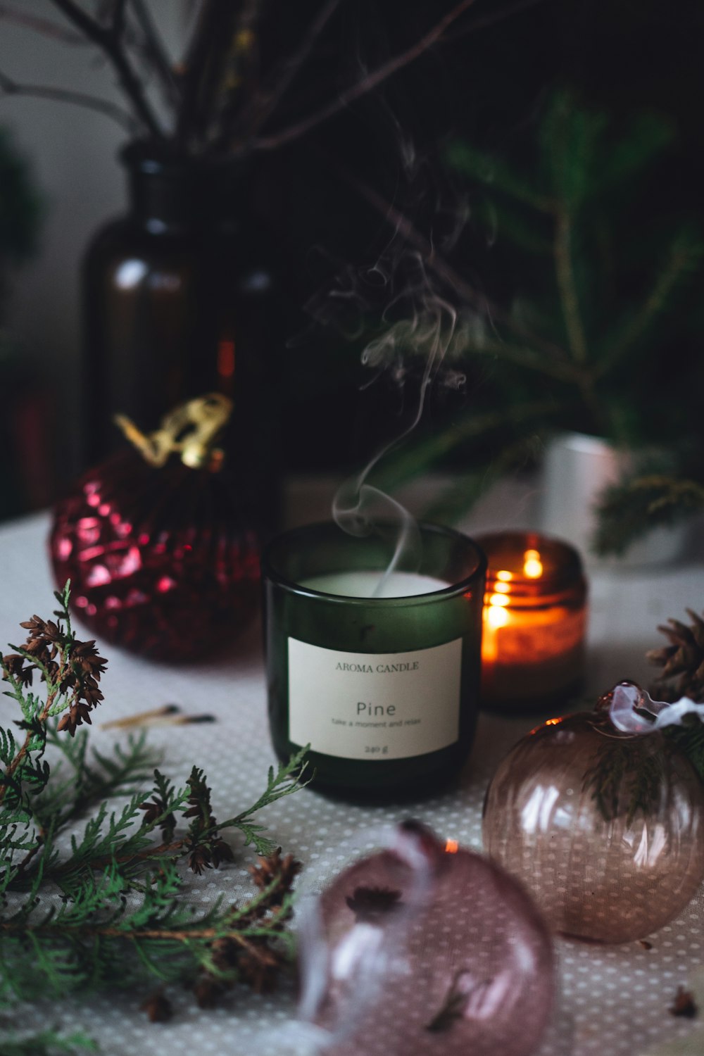 a candle sitting on top of a table next to ornaments