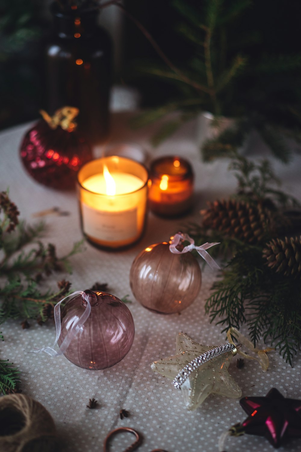 a table topped with candles and ornaments