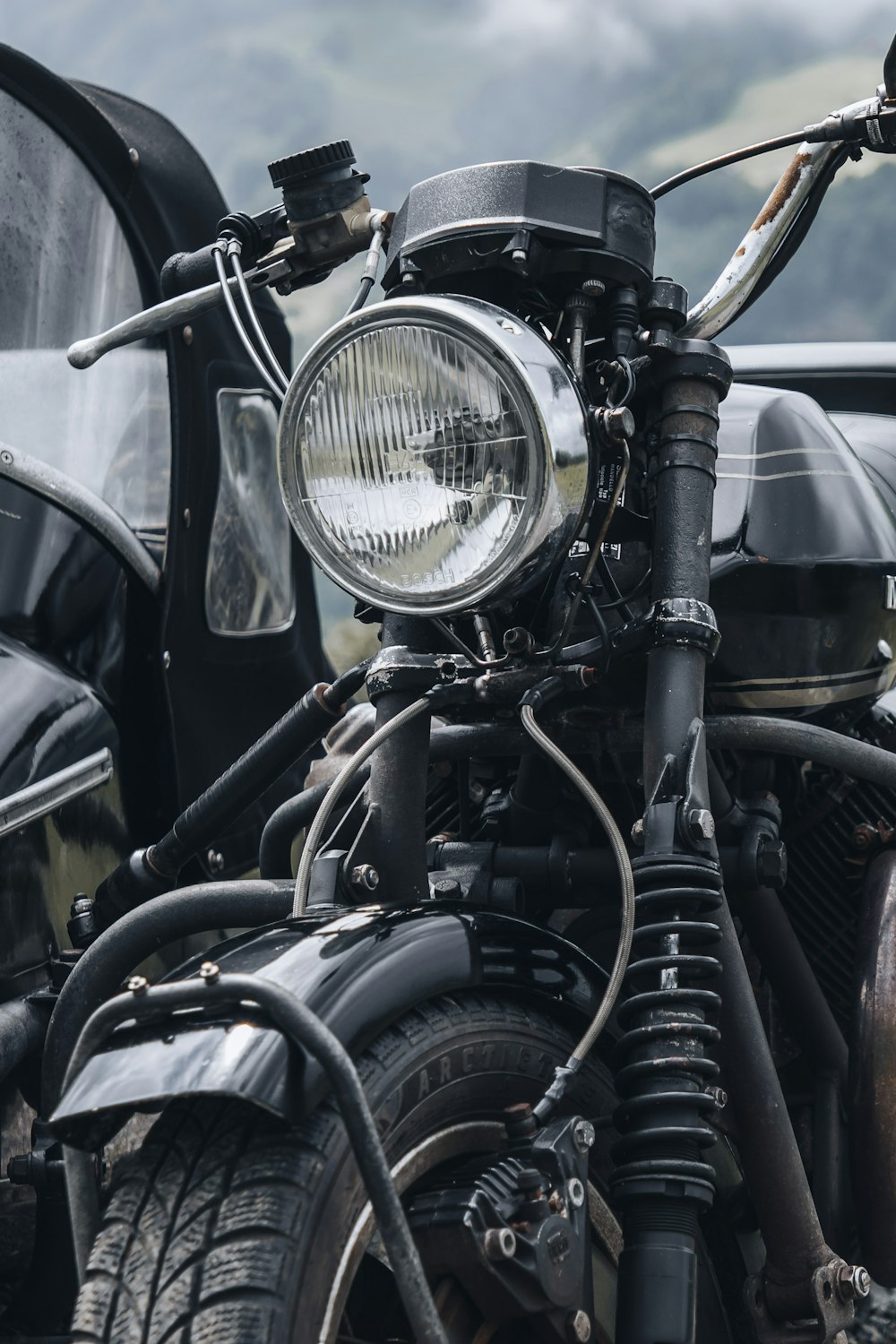 a close up of a motorcycle with a foggy background