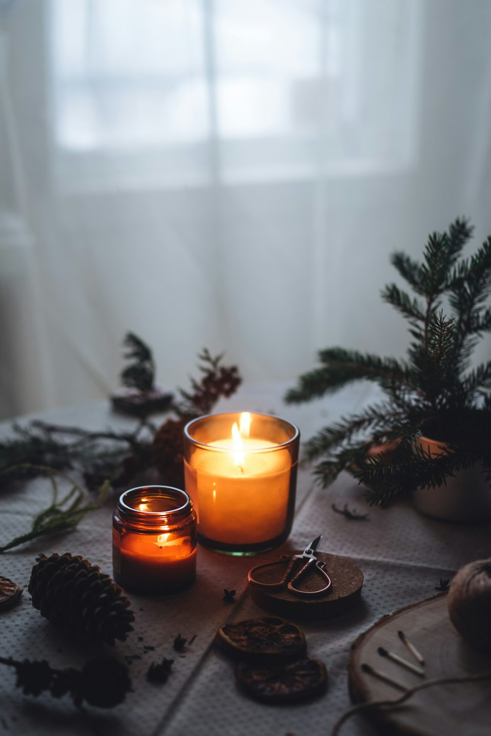 a lit candle sitting on top of a table