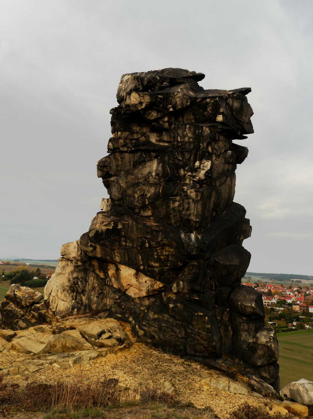 a large rock formation on top of a hill