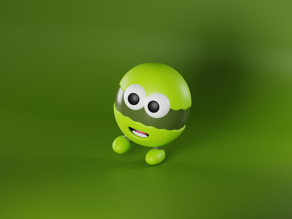 a green object with eyes and a smile