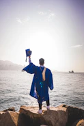 a man standing next to a body of water