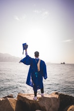 a man standing next to a body of water