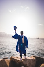 a man standing next to a body of water