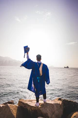 a man standing next to a body of water