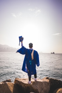 a man standing next to a body of water