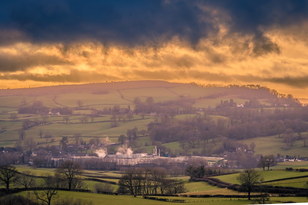 a scenic view of a rural countryside at sunset