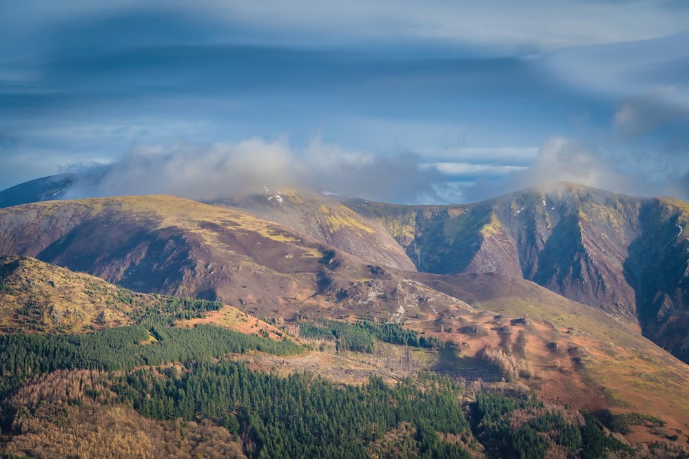 a view of a mountain range with clouds in the sky