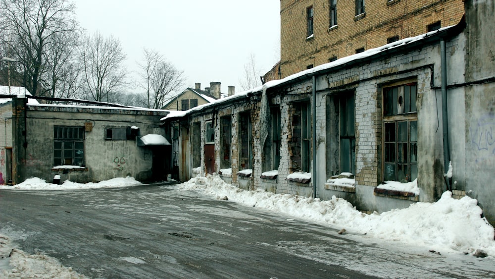 an old run down building with snow on the ground
