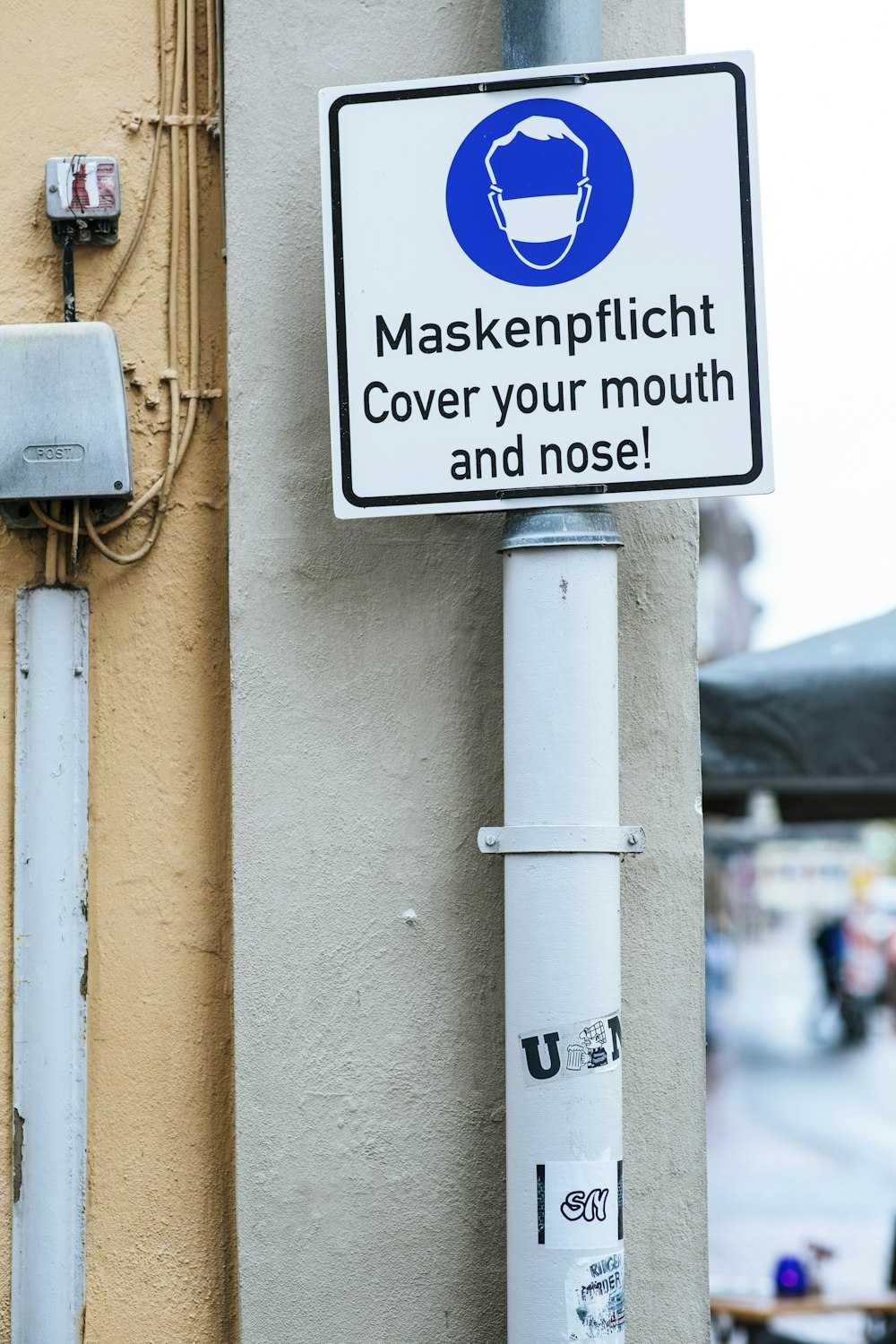 a sign on a pole on the side of a building
